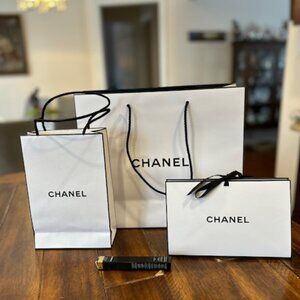 3 different sizes authentic Chanel shopping bags with Chanel eyeliner